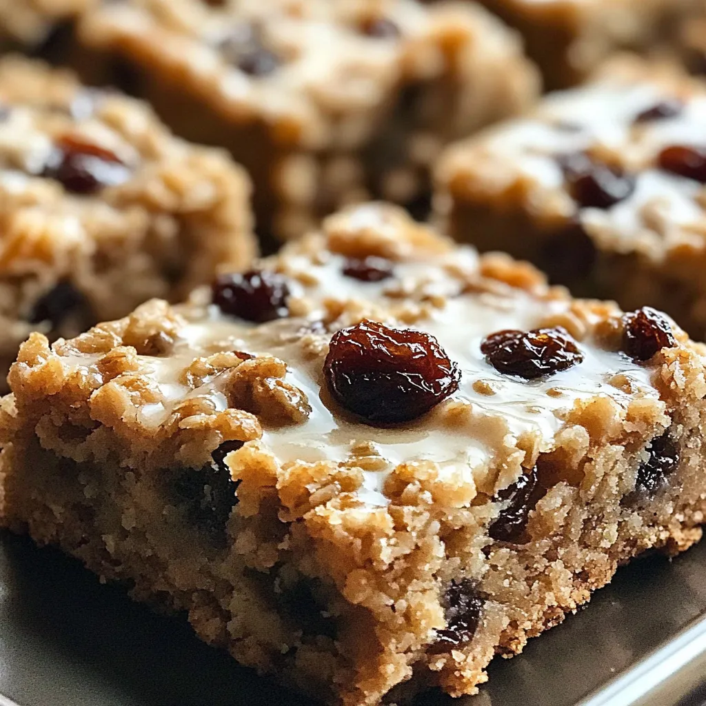A close up of a square cake with raisins.