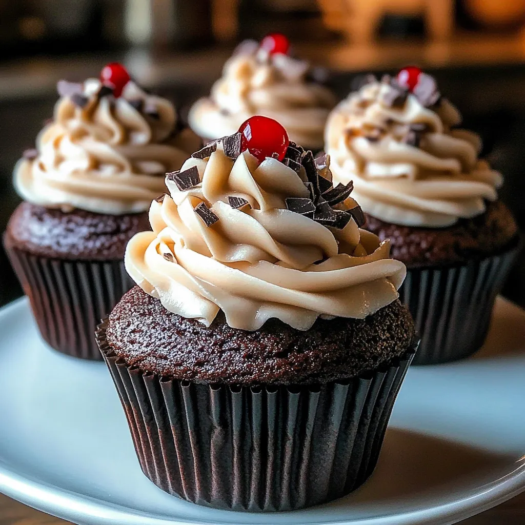 Chocolate cupcakes with white frosting and red cherries.