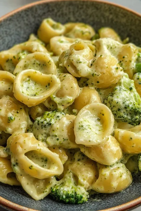 A bowl of pasta with broccoli.