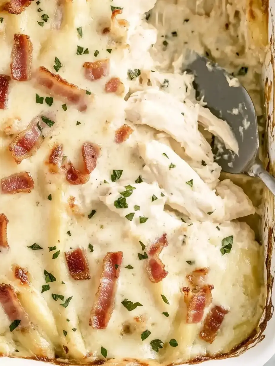 A creamy chicken casserole topped with crispy bacon and parsley.